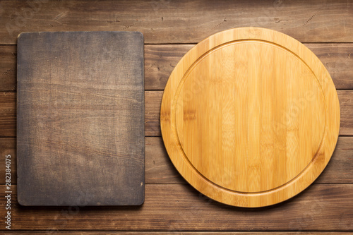pizza cutting board at wooden plank board background