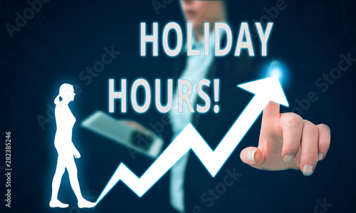 Text sign showing Holiday Hours. Business photo text Overtime work on for employees under flexible work schedules Female human wear formal work suit presenting presentation use smart device