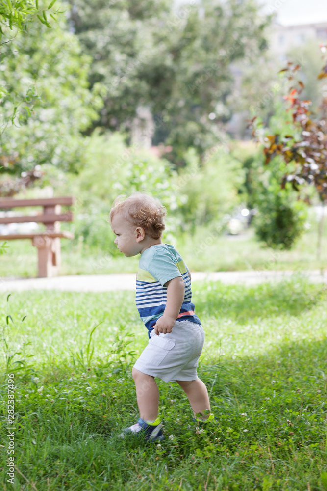 Portrait child boy playing in park.Concept of summer,childhood and leisure Portrait child boy playing in park.Concept of summer,childhood and leisure