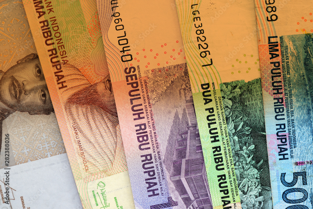 Several Indonesian rupiah close up. Money background brown color toned Several Indonesian rupiah close up. Money background brown color toned