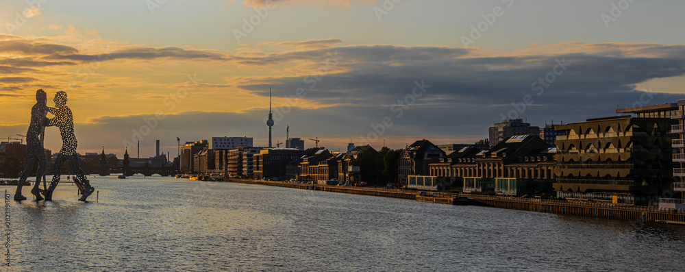 View on the Molecular men with TV tower at sunset in Berlin, Germany