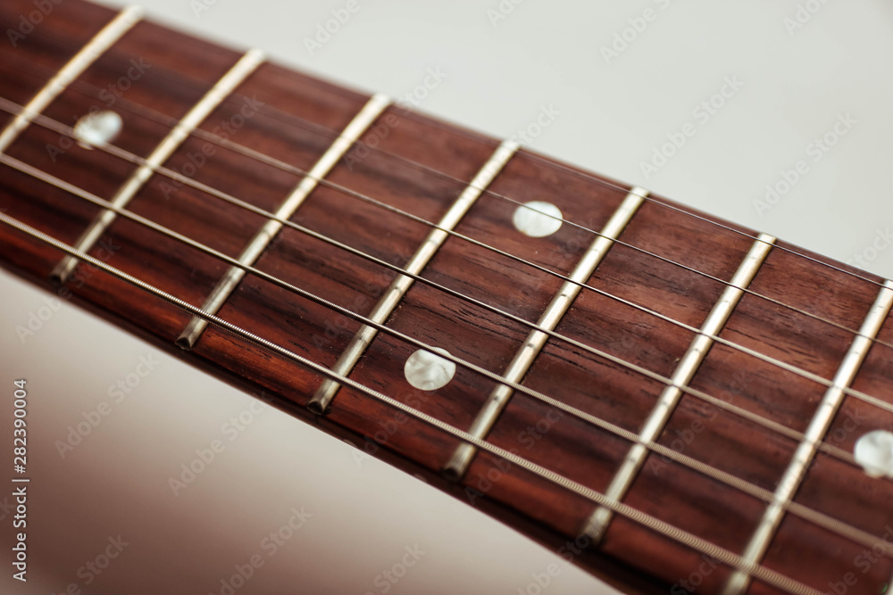 Guitar neck and strings close up top view on white background. Guitar neck and strings close up top view on white background.