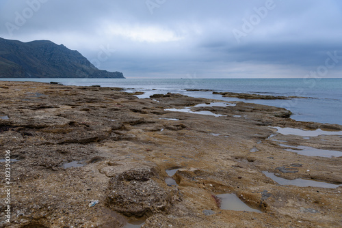 Black Sea coast on a cloudy day with clouds in the sky.