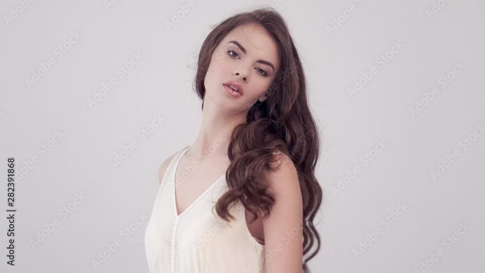 Girl turns around and looks into the camera. Beautiful woman with long brown hair. Girl turns around and looks into the camera. Beautiful woman with long brown hair.