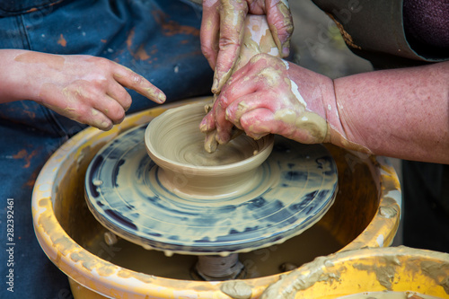 Ukrainian pottery.Creating a sculpture of clay close-up. Hands making products from clay. Pottery museum in Ukrainian village Oposhnya, center of Ukrainian pottery production.
