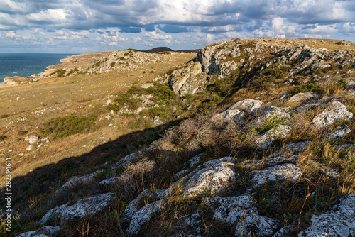 The beaches of the generals of the Crimean peninsula on a sleepy day with clouds in the sky, shot during the season of golden autumn yellow-golden brown. photo