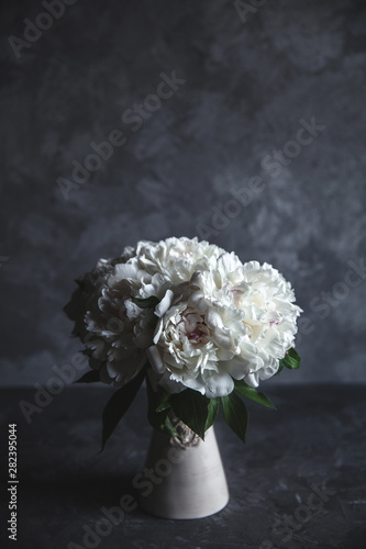Beautiful peonies on grey concrete background. Wedding, birthday, valentine's day, gift or women's day concept