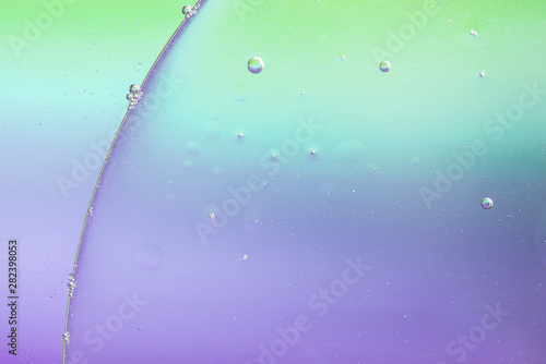 Small air bubbles on big oil drop in water background