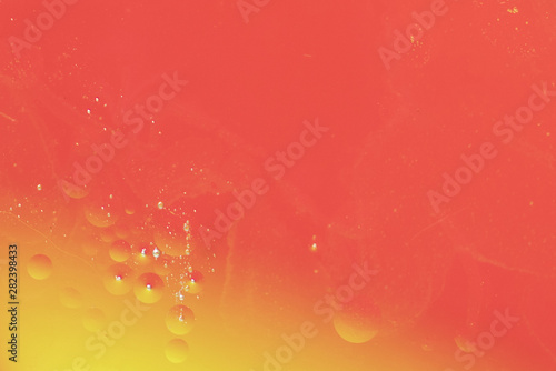 Abstract oil drops on hued defocused background