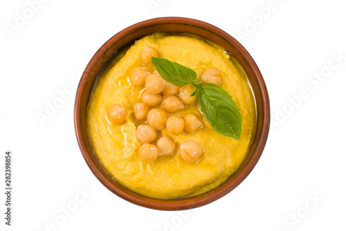 Hummus in a bowl isolated on white top view