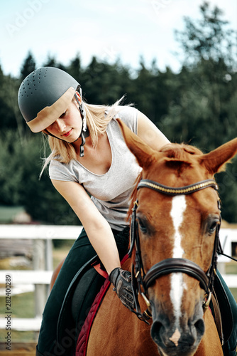 young girl rider in equipment on horseback. Horseback Riding.