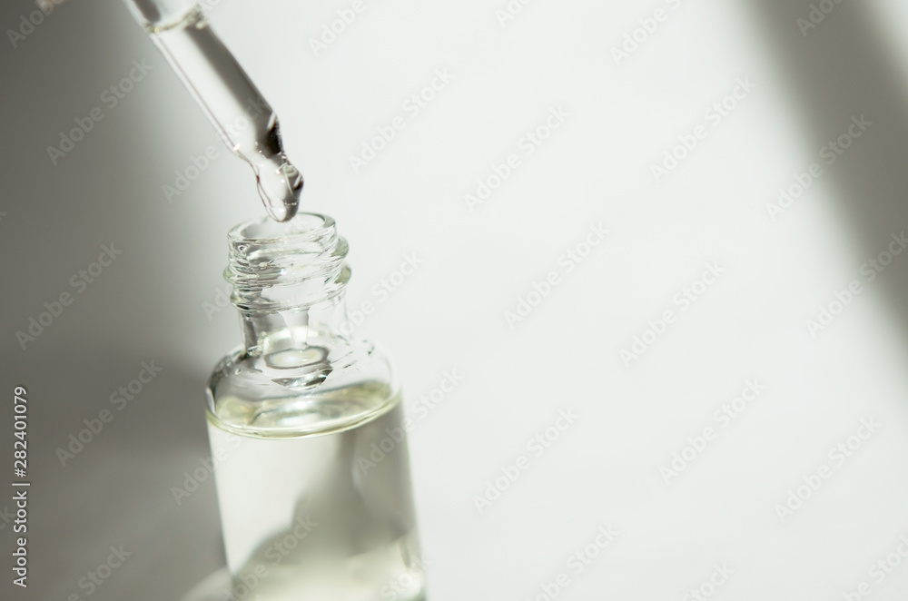 Cosmetic or medical glass bottle with pipette on white background. Skin care concept. Natural hard light, deep shadows. - Image Cosmetic or medical glass bottle with pipette on white background. Skin care concept. Natural hard light, deep shadows. - Image