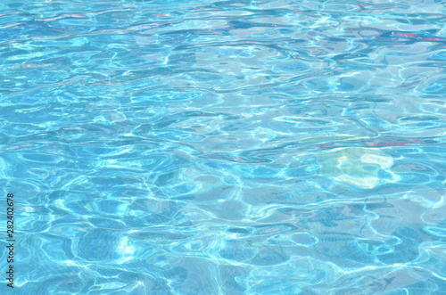 Surface of blue swimming pool. Background texture of water. - image © ireneromanova