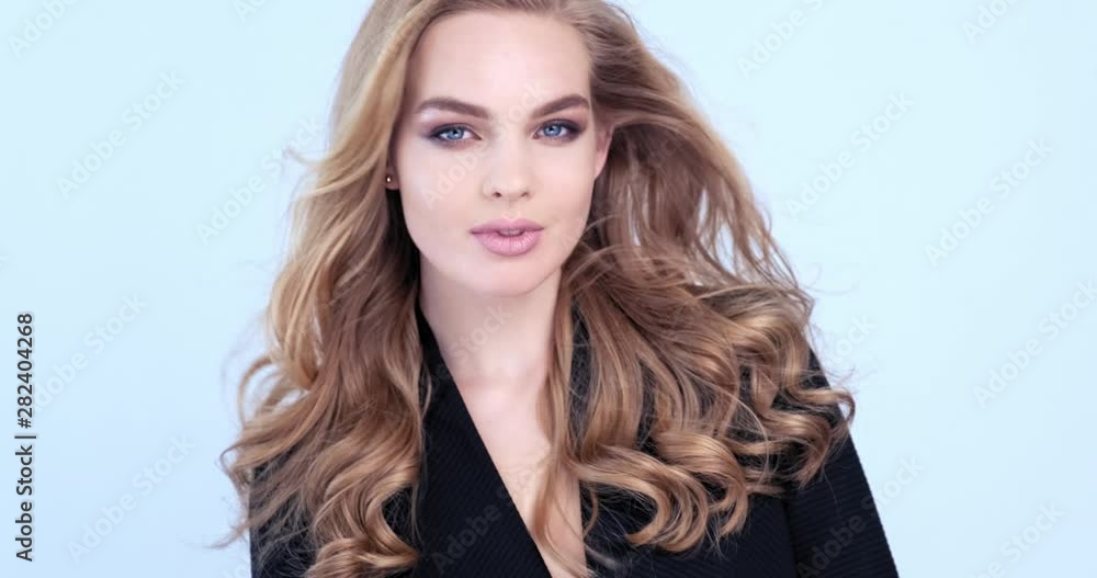 Beautiful young blonde woman with long hair. Fashion model looks to the camera. Stunning face of a caucasian girl. Sexy model with a beautiful blue eyes. Slow motion. Beauty concept. 4k footage. Beautiful young blonde woman with long hair. Fashion model looks to the camera. Stunning face of a caucasian girl. Sexy model with a beautiful blue eyes. Slow motion. Beauty concept. 4k footage.