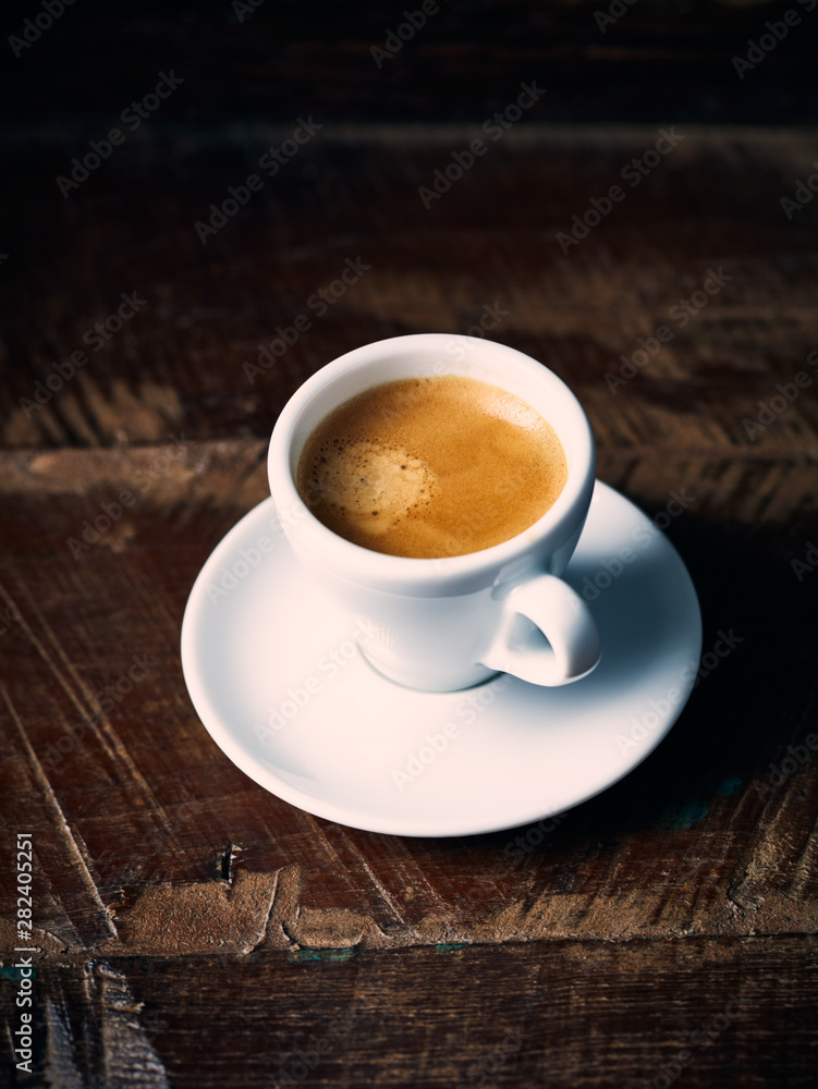 Cup of espresso coffee on rustic wooden background