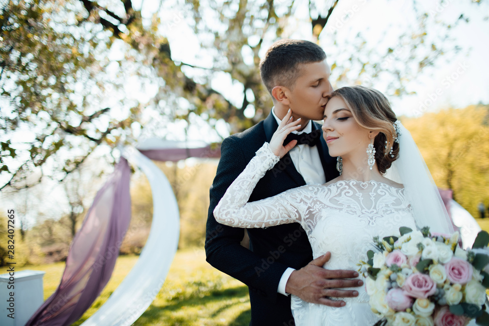Walk the newlyweds. The bride and groom in nature. Wedding day. The best day of a young couple Walk the newlyweds. The bride and groom in nature. Wedding day. The best day of a young couple