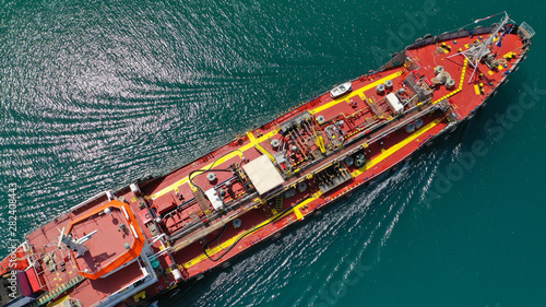 Aerial top view photo of industrial fuel supply vessel cruising in Mediterranean port © aerial-drone