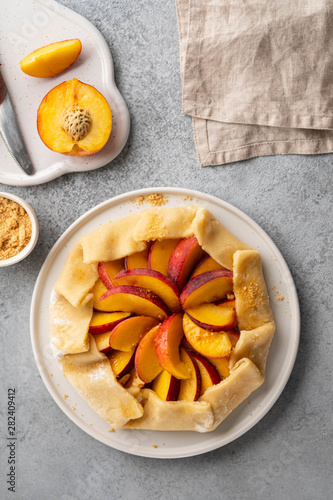 Appetite summer peach galeta on white table with copy space. summer open tart photo for cook book or food blog.