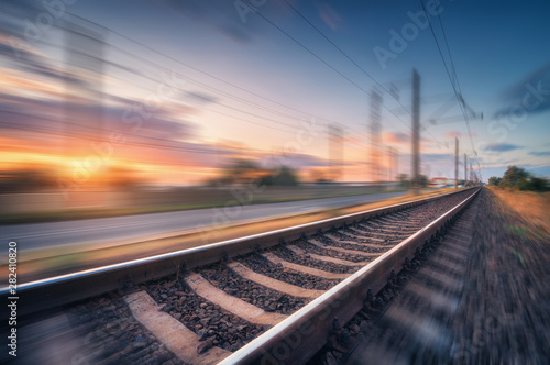 Obraz na płótnie Railroad and beautiful blue sky with clouds at sunset with motion blur effect in summer
