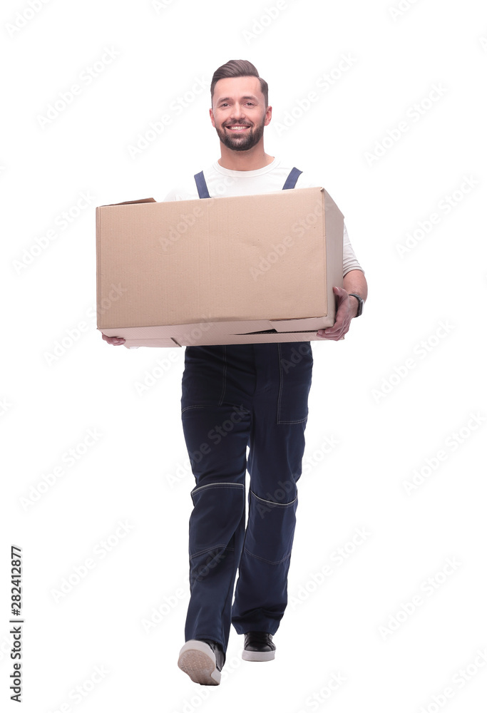 in full growth. smiling man carries a large cardboard box in full growth. smiling man carries a large cardboard box