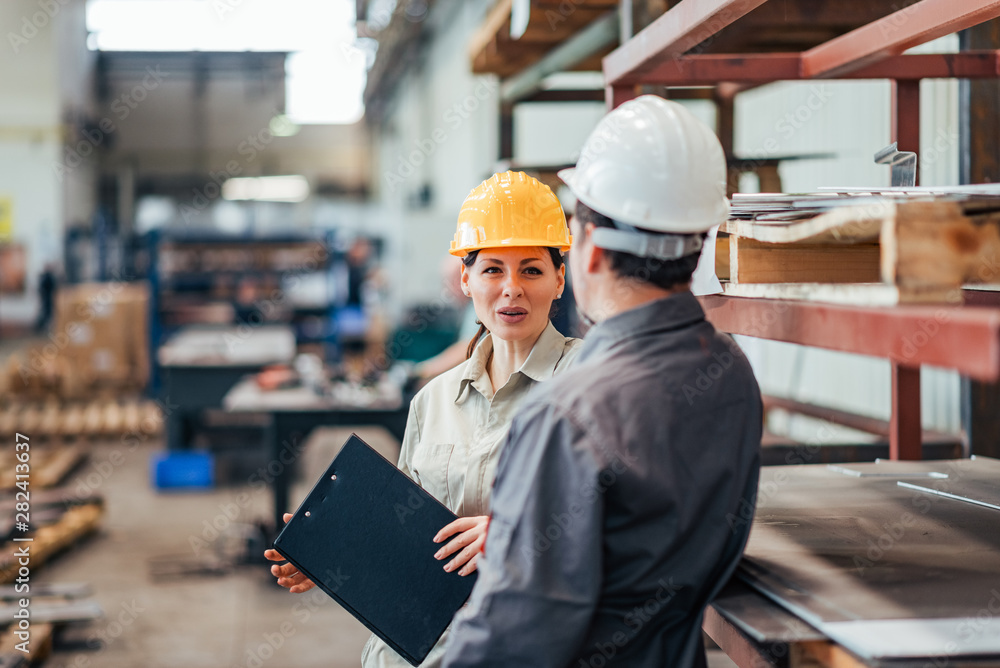 Supervisor and factory worker discussing at work. Supervisor and factory worker discussing at work.