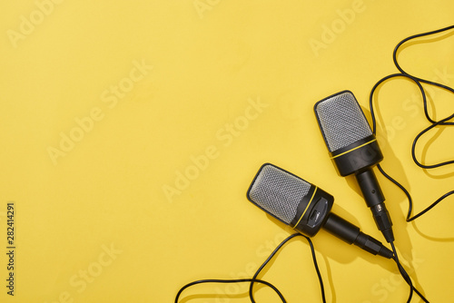 top view of microphones on bright and colorful background with copy space