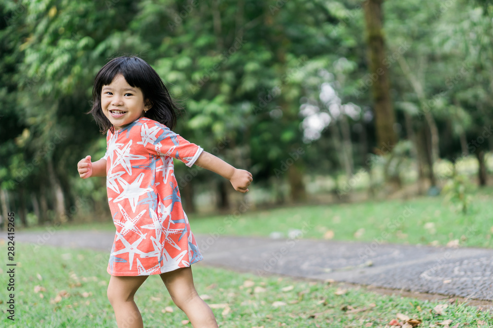 asian cute girl with smile enjoy playing alone in the garden asian cute girl with smile enjoy playing alone in the garden