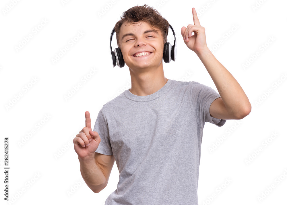 Happy teen boy with headphones, isolated on white background. Cheerful child listening to music, singing song and dancing. Emotional portrait of handsome teenager guy enjoying music. Happy teen boy with headphones, isolated on white background. Cheerful child listening to music, singing song and dancing. Emotional portrait of handsome teenager guy enjoying music.