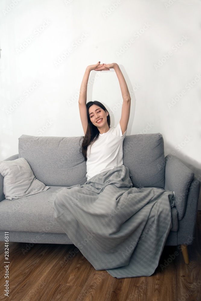 Asian woman relaxed and resting breathing fresh on sofa at home. Asian woman relaxed and resting breathing fresh on sofa at home.