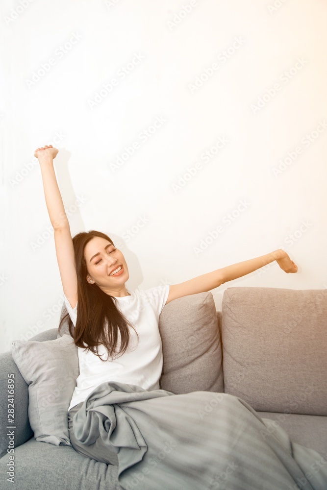 Asian woman relaxed and resting breathing fresh on sofa at home. Asian woman relaxed and resting breathing fresh on sofa at home.