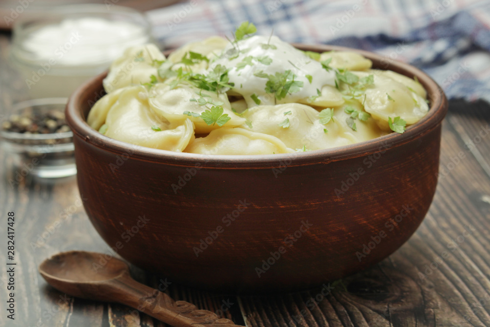 A ceramic bowl with freshly cooked Russian vareniki with mashed potato A ceramic bowl with freshly cooked Russian vareniki with mashed potato