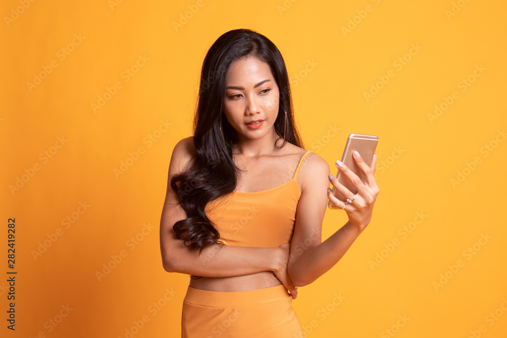 Young Asian woman with mobile phone. Young Asian woman with mobile phone.