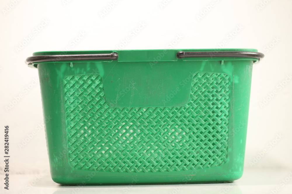 Green plastic shopping basket with black handles. Green plastic shopping basket with black handles.