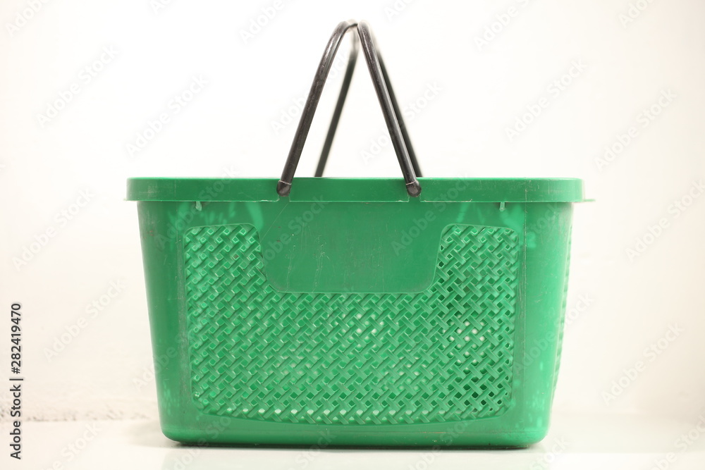 Green plastic shopping basket with black handles. Green plastic shopping basket with black handles.