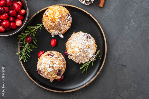 Muffins, cakes with cranberry, rosemary and almond nuts. Christmas decoration. Copy space.
