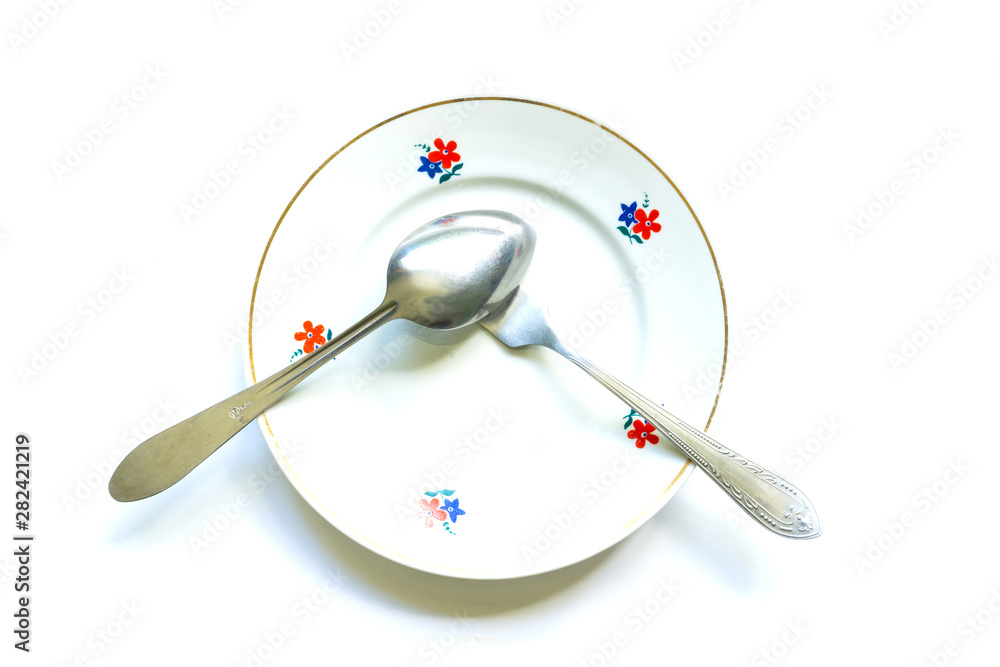 fork and spoon on an empty clean plate fork and spoon on an empty clean plate