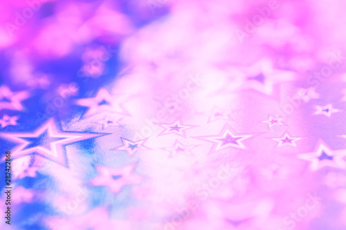 Sparkling golden glitter abstract background purple blue desaturated color  fluid defocused  macro. Foil silver stars. party festive celebration background