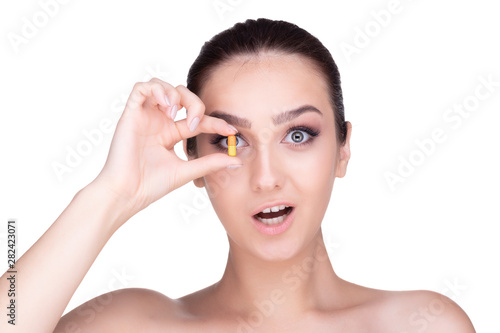 girl holds a tablet close to the eye . isolate