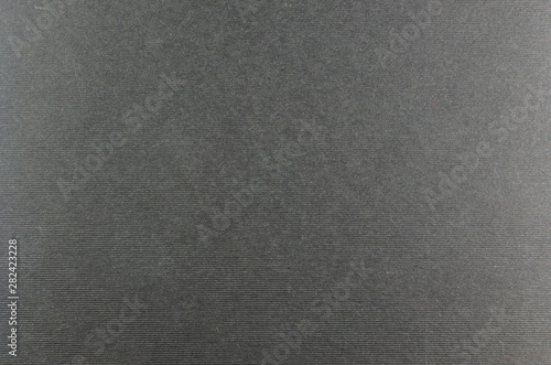 Dark grey cardboard with relief horizontal lines suitable as a background