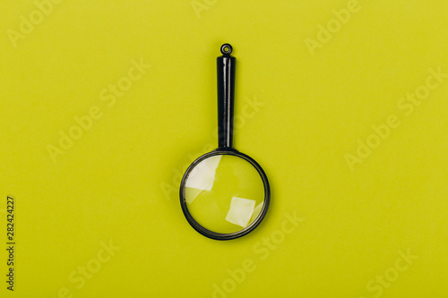 Small magnifying glass on green background