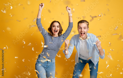 joyful couple on yellow background photo