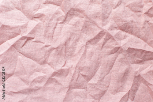 light pink background with crumpled linen cloth, free space for text