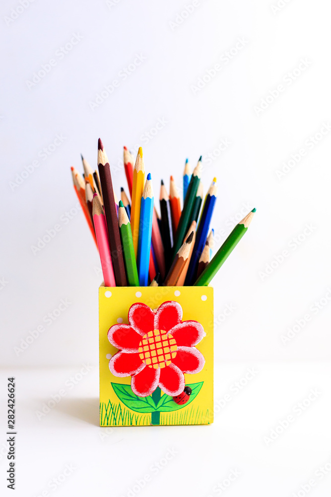 Fototapeta premium Colored pencils in a pencil case on white background