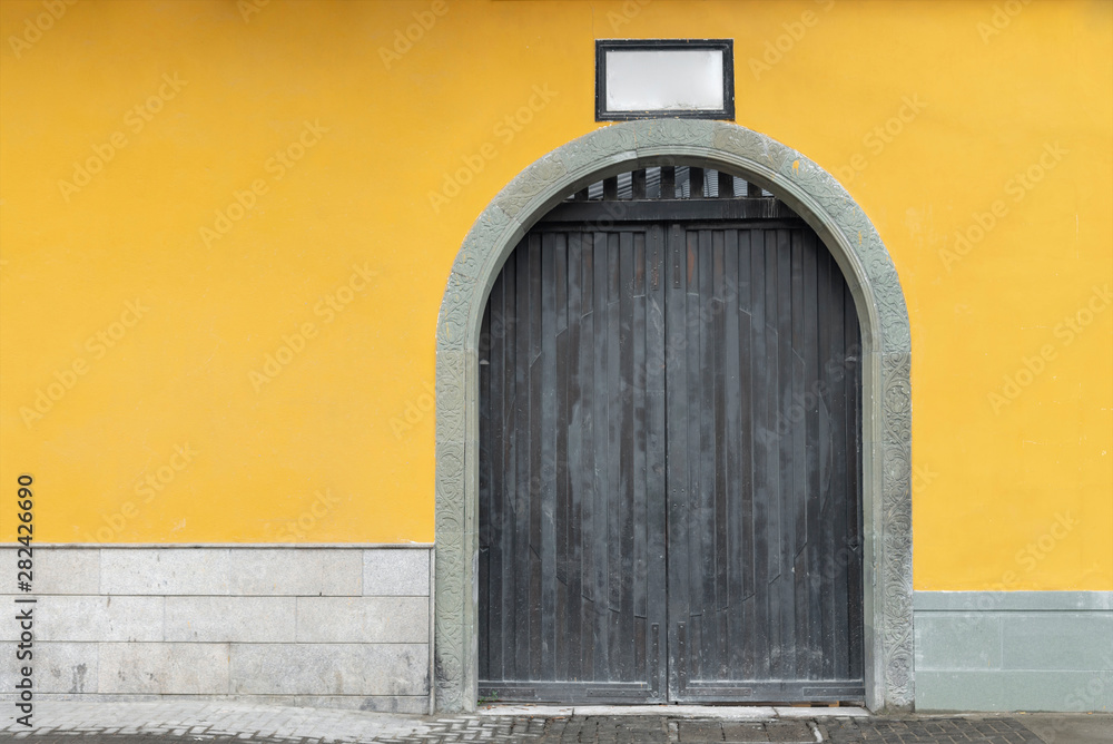 Fototapeta premium yellow wall and door stone at the jade Buddha temple, Shanghai, china