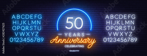Fifty years anniversary neon sign on a dark background. Neon alphabet . Template for invitation or greeting card.