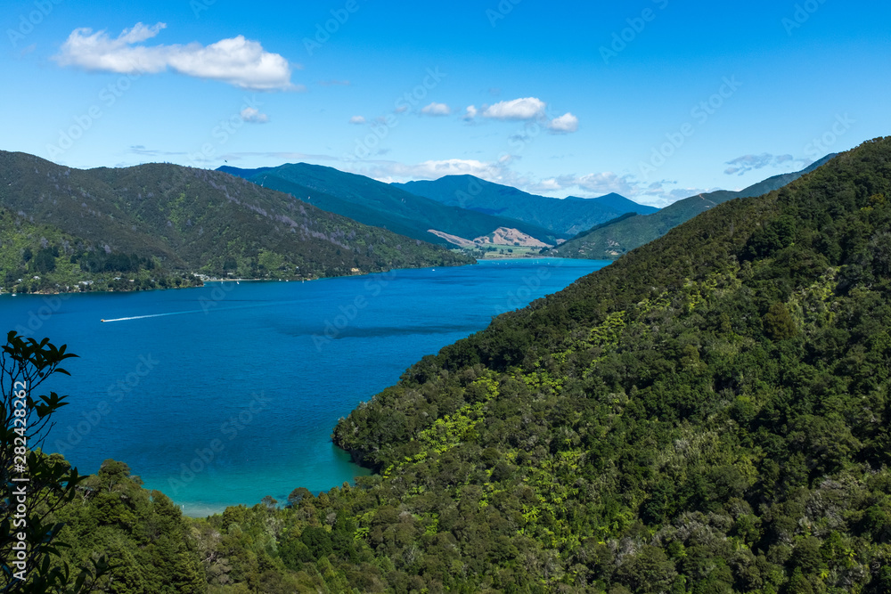 Looking down the length of the beautiful and stunning Marlborough Sound and the surrounding hills at the top of the South Island, New Zealand on a sunny day.