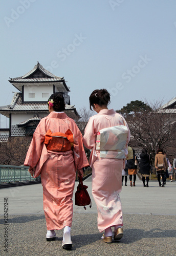 Two Japanese women in traditional kimono walking towards Kanzawa castle