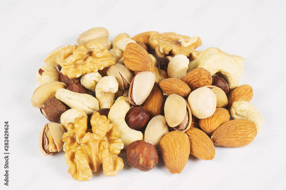 Mix nuts and dry fruits on a white background Mix nuts and dry fruits on a white background