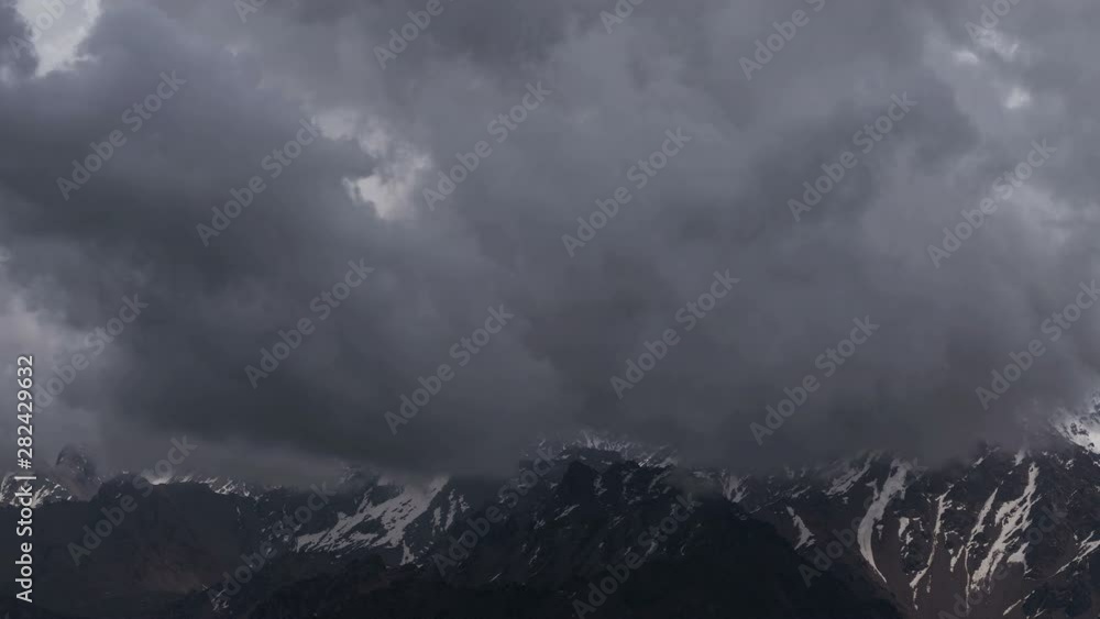Mountain peak dissolves in the clouds. Time lapse. Mountain peak dissolves in the clouds. Time lapse.