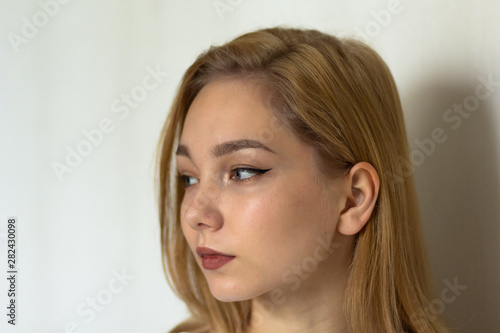 Portrait of the beautiful young woman looking aside